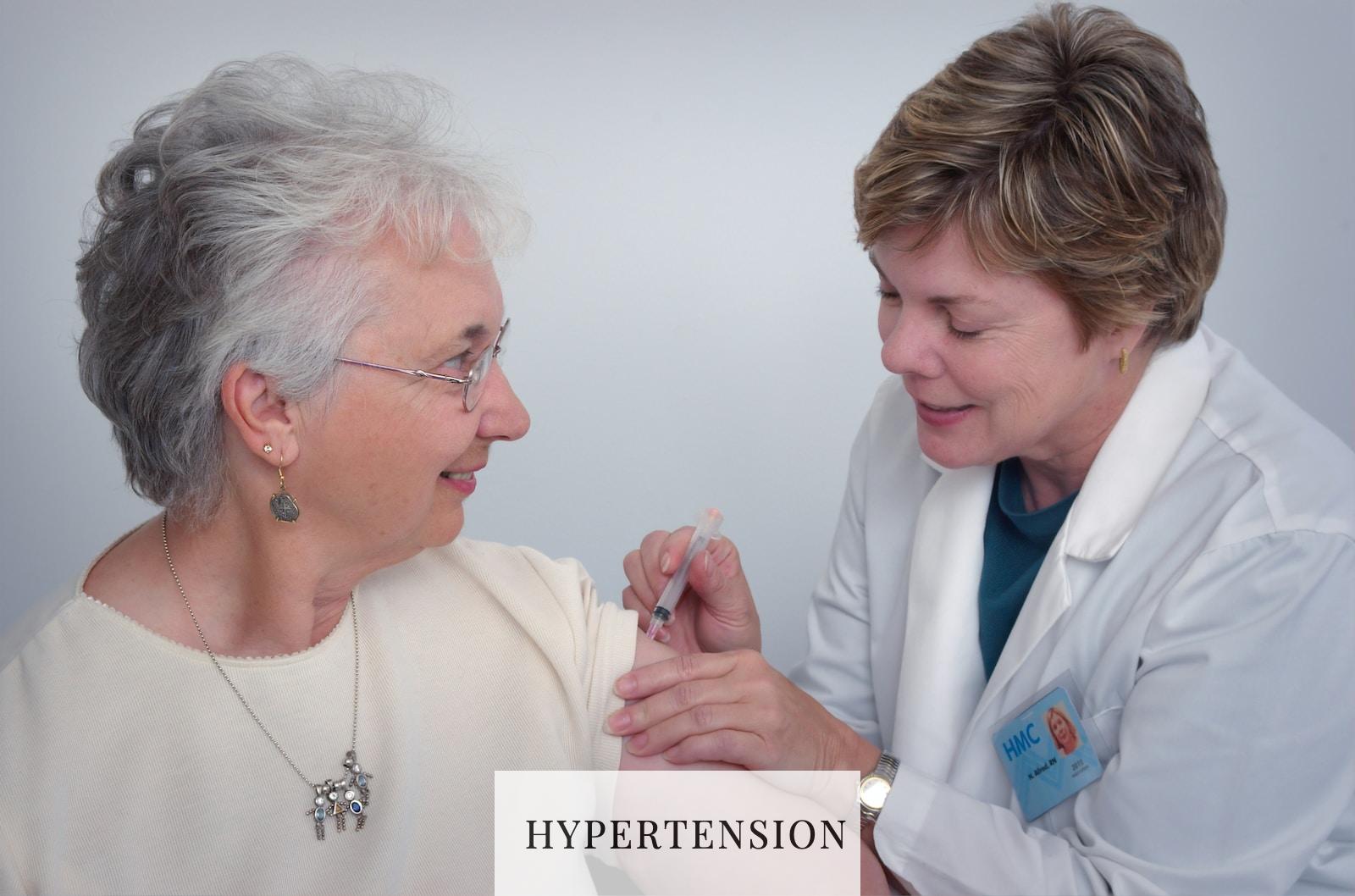woman inject a woman on left shoulder